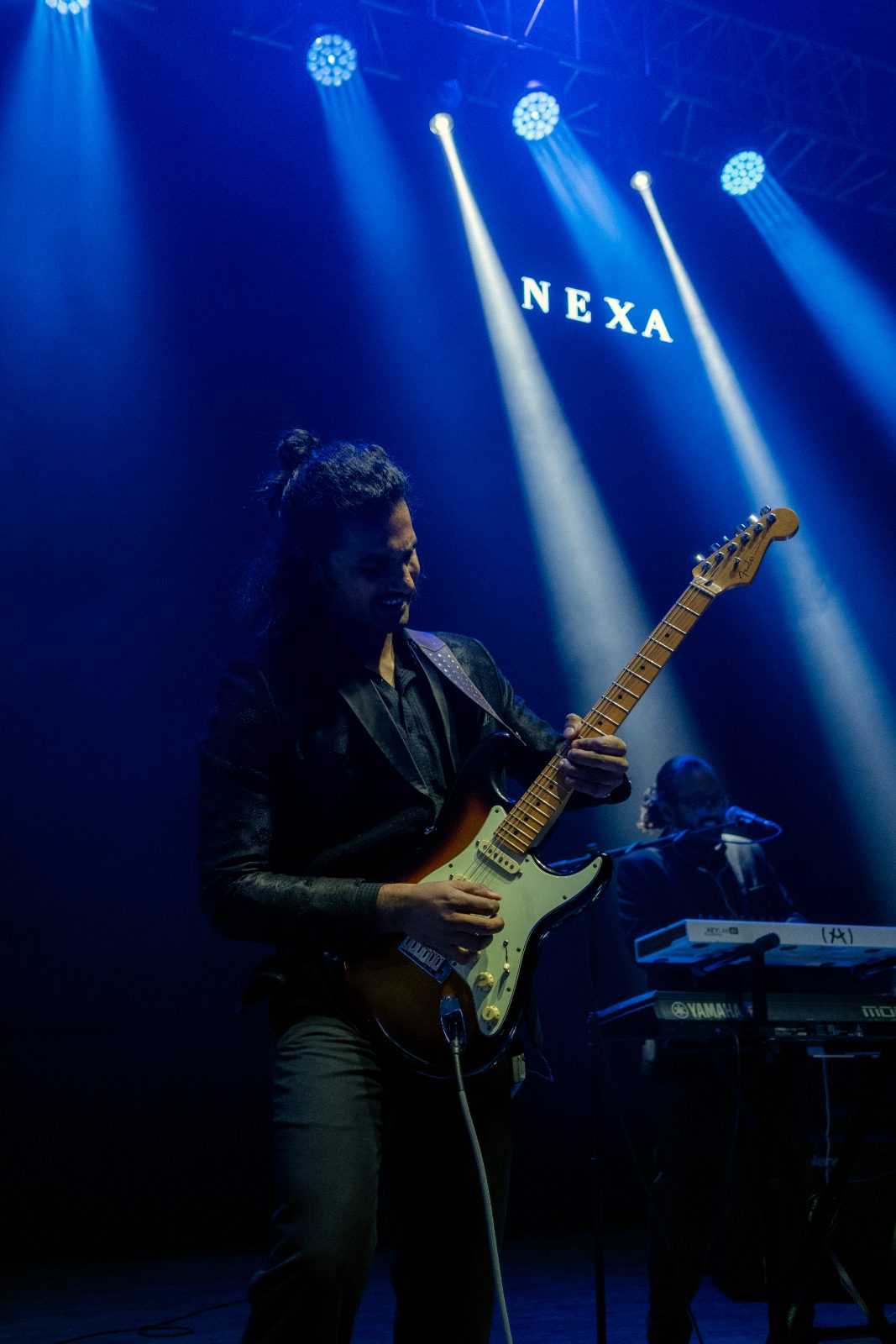 Guitarist under blue stage light