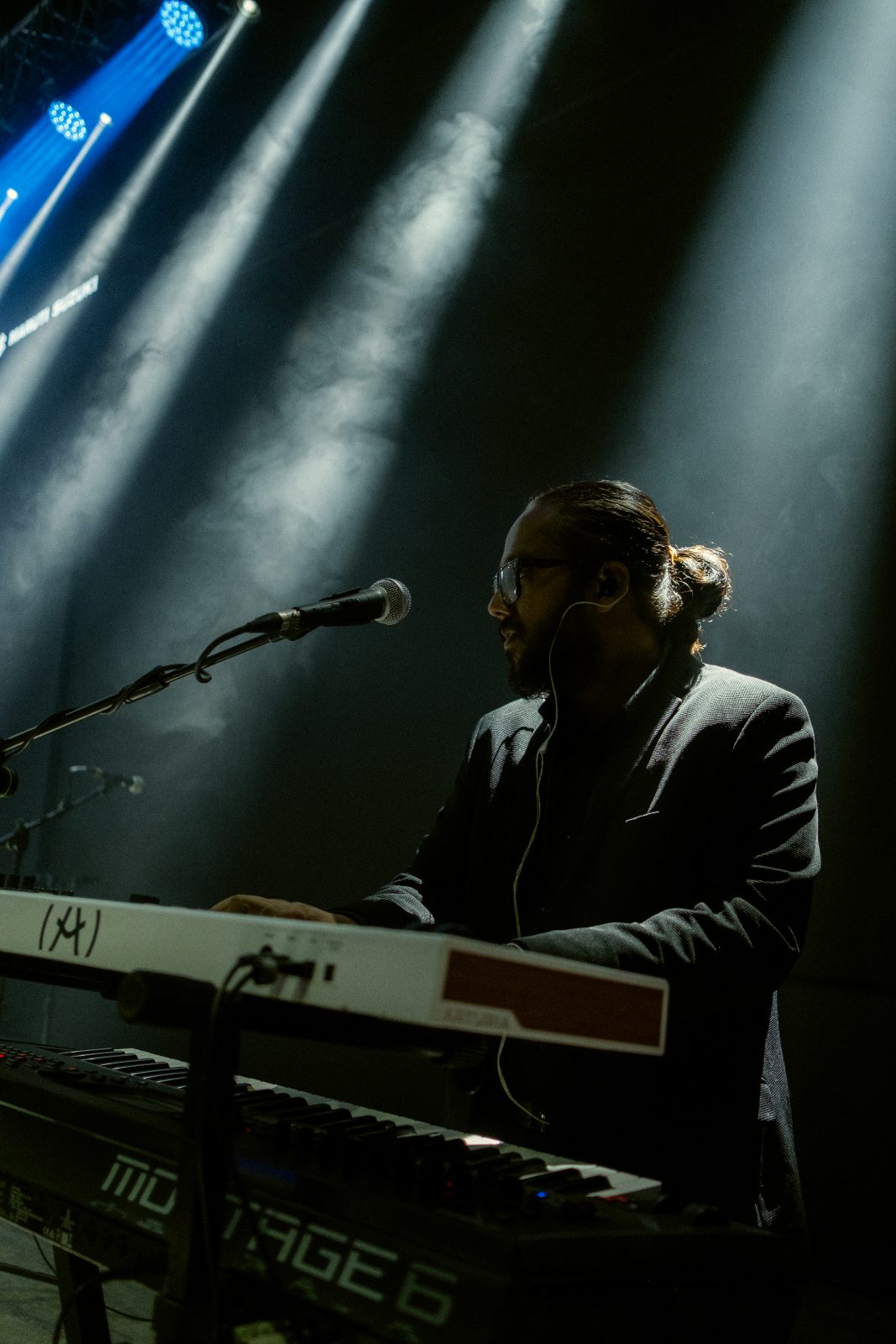 Keyboard player in dramatic side light